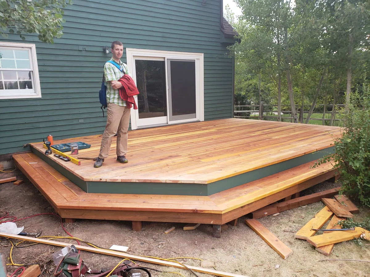 Finished cedar deck with homeowner for scale